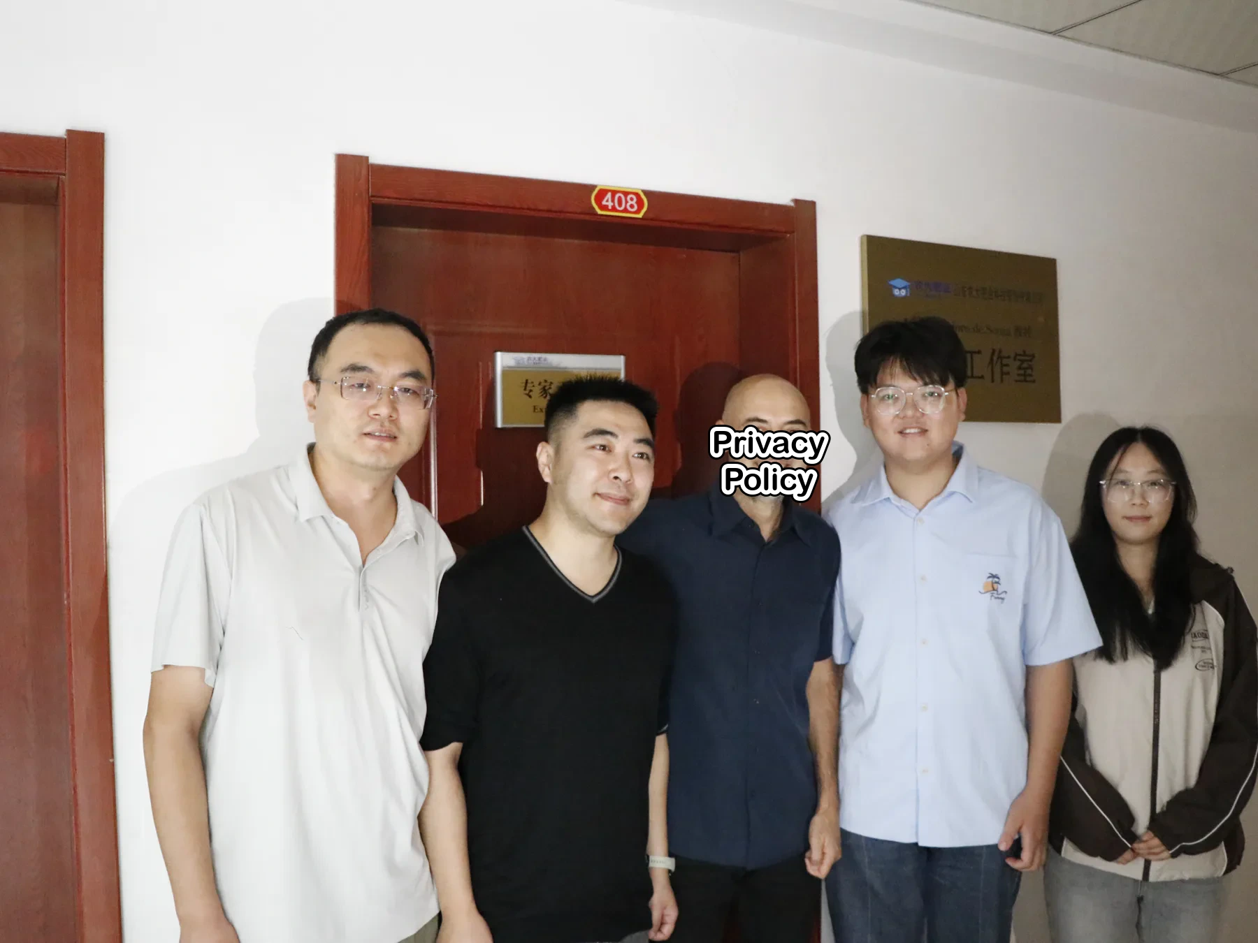 Professor Jorge and staff taking a group photo at the studio